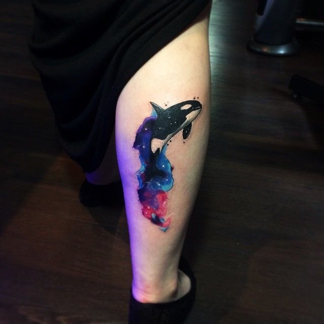 Colored orca tattoo on calf for women