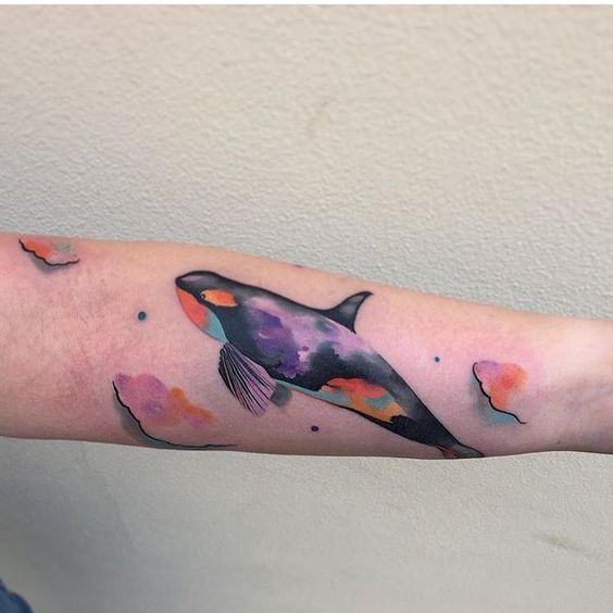 Colored orca tattoo on the forearm for women