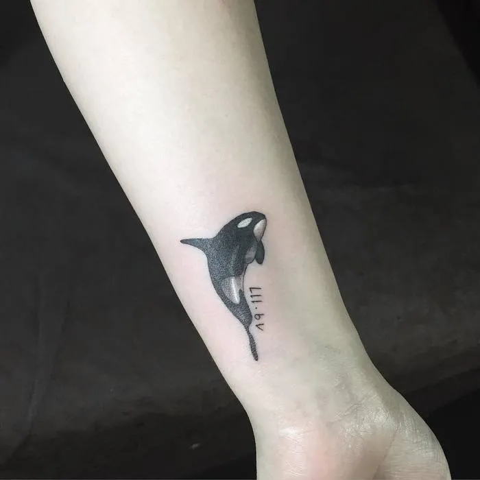 Orca tattoo on forearm for women