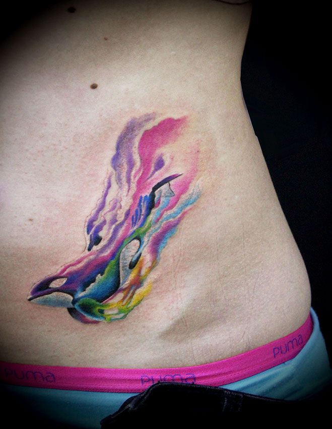 Colored orca tattoo on the abdomen for women