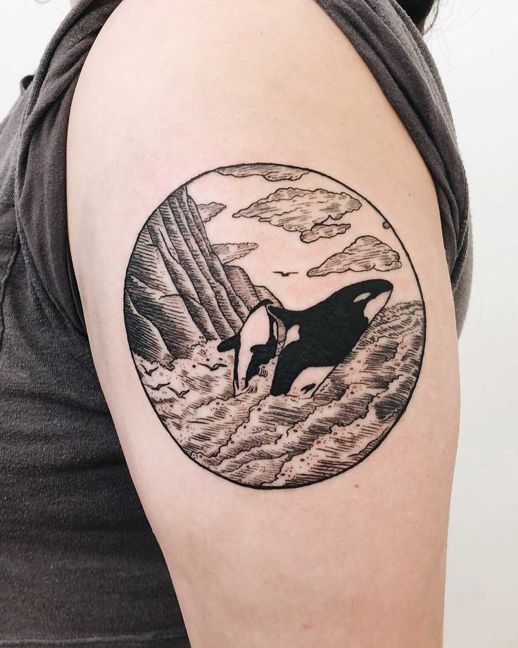 Tattoo of two orcas on the shoulder for men