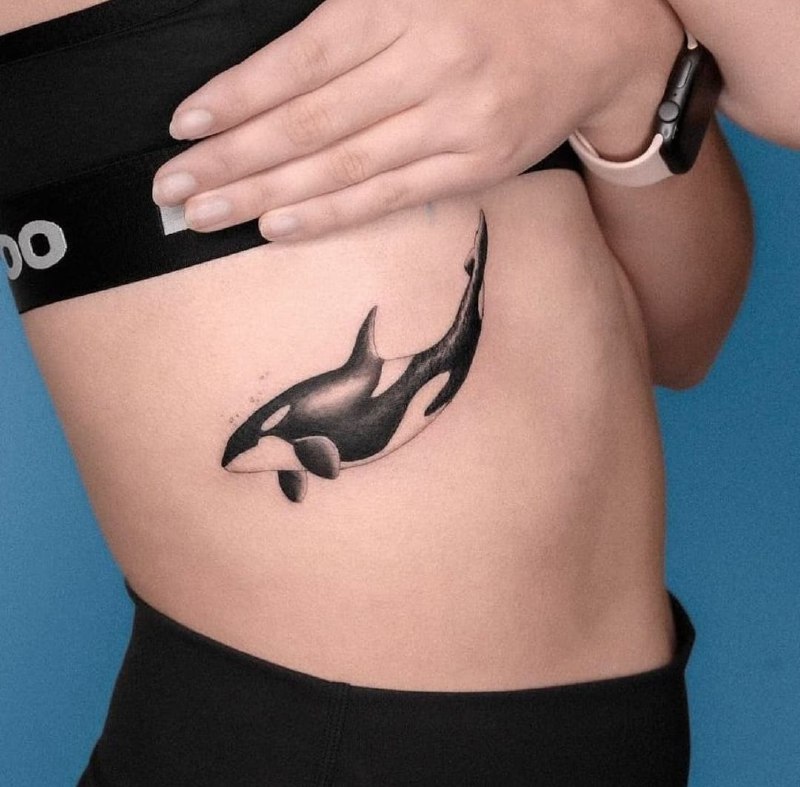 Orca tattoo on the side for women