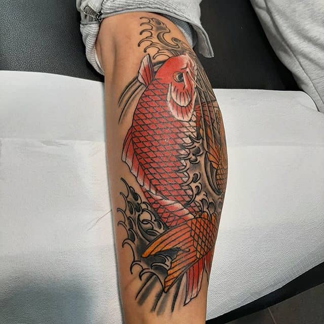 Large carp tattoo on the shin for men