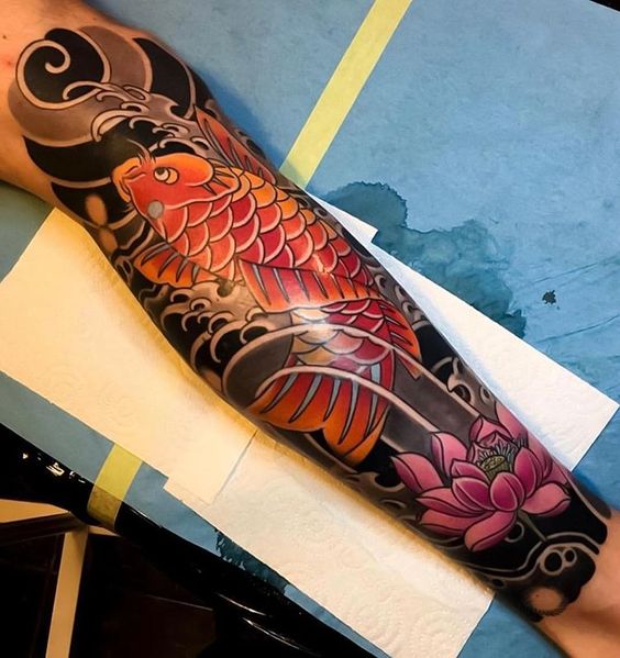 Color carp tattoo on the leg for men