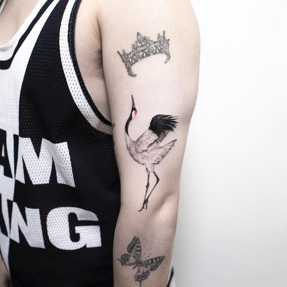 Color tattoo of a crane on the shoulder for men