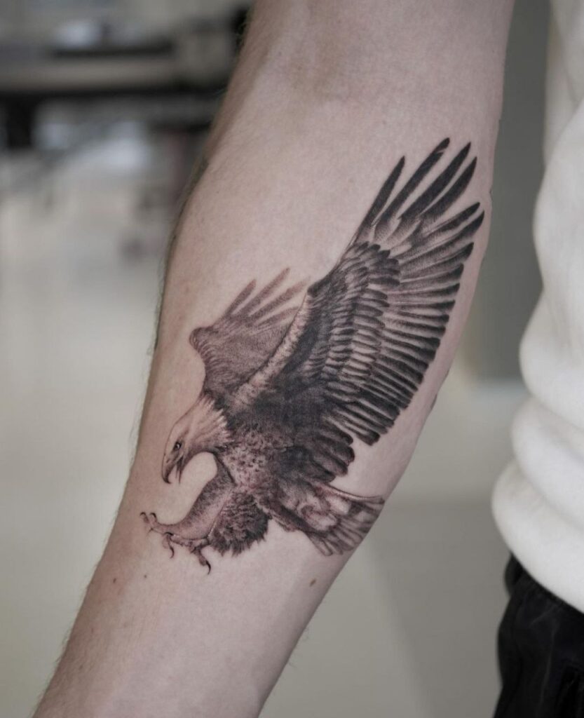 Large tattoo of an eagle on the forearm for men