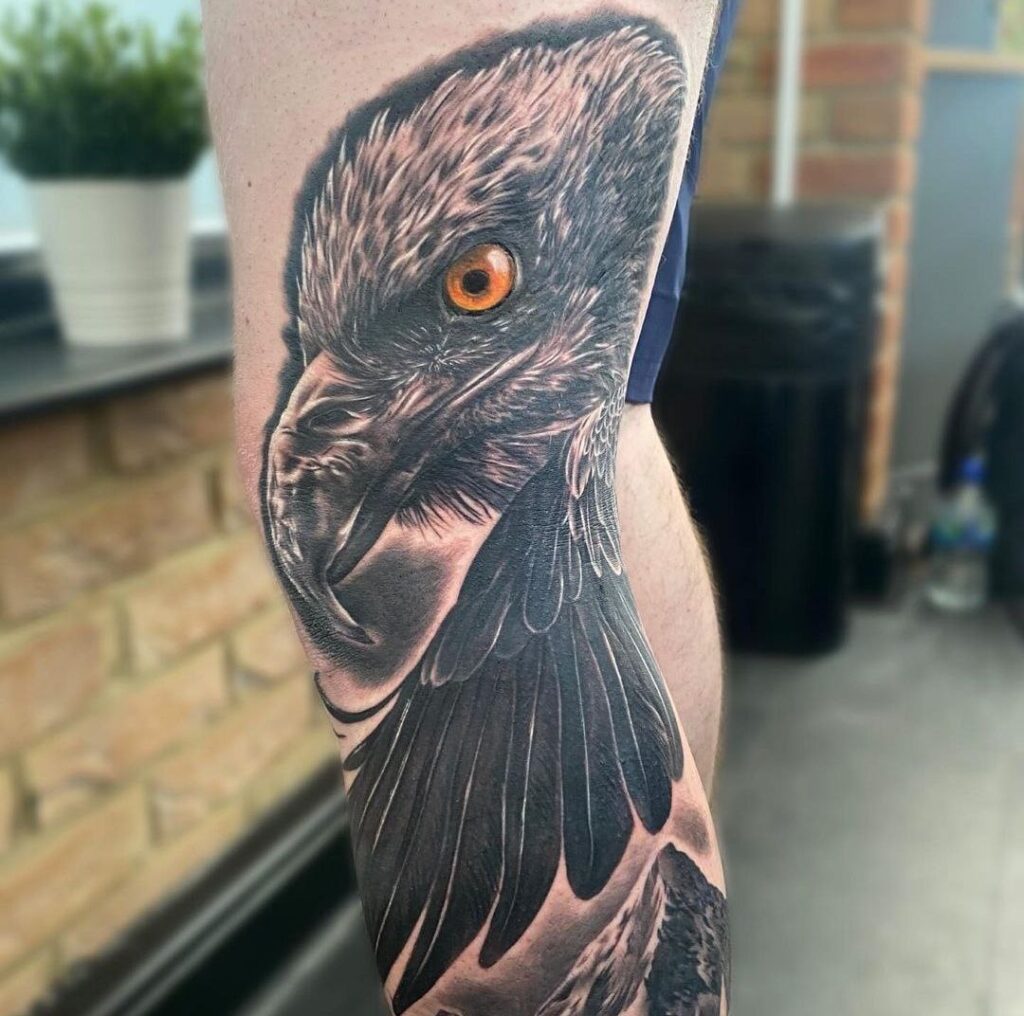 Large tattoo of an eagle on the leg for men