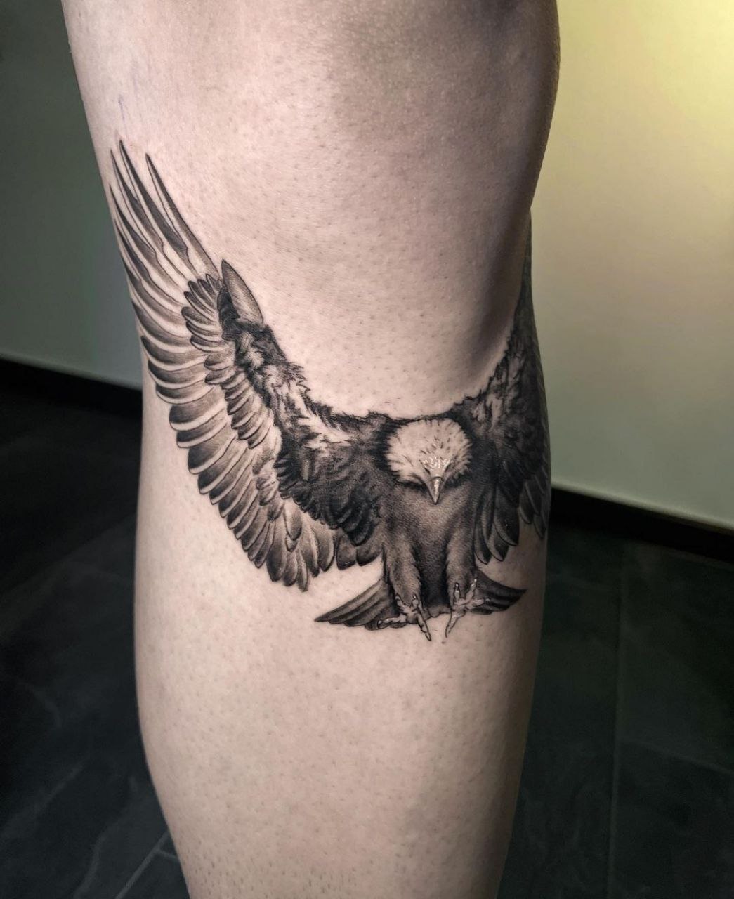 Large eagle tattoo on the shin for men