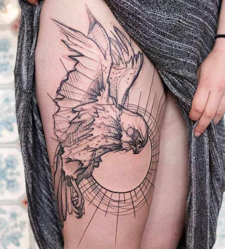 Large falcon tattoo on the thigh for women