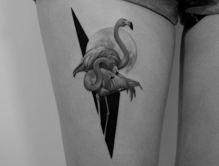 Large tattoo of two flamingos on the thigh for women