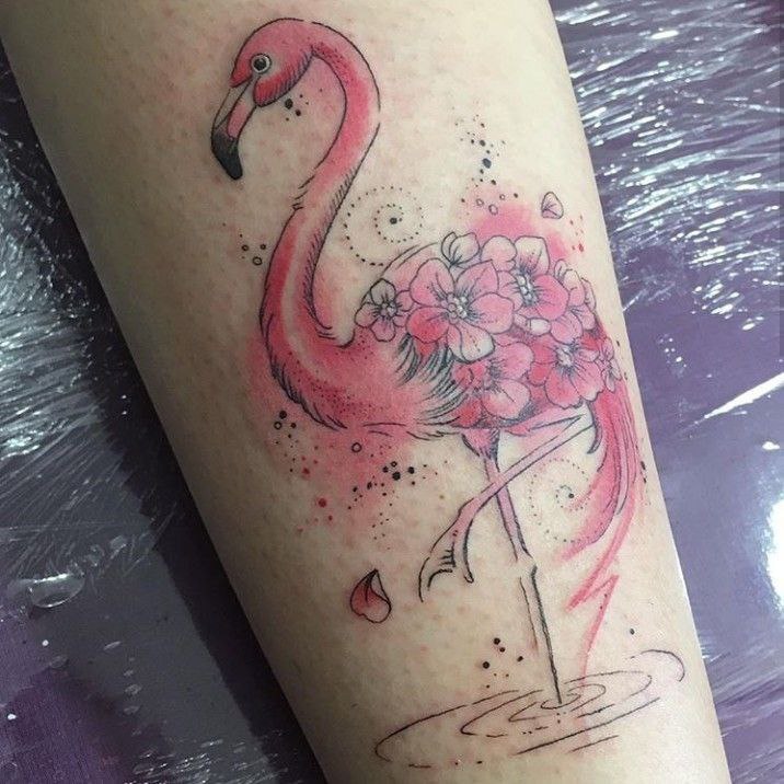 Flamingo tattoo with flowers on the shin for women