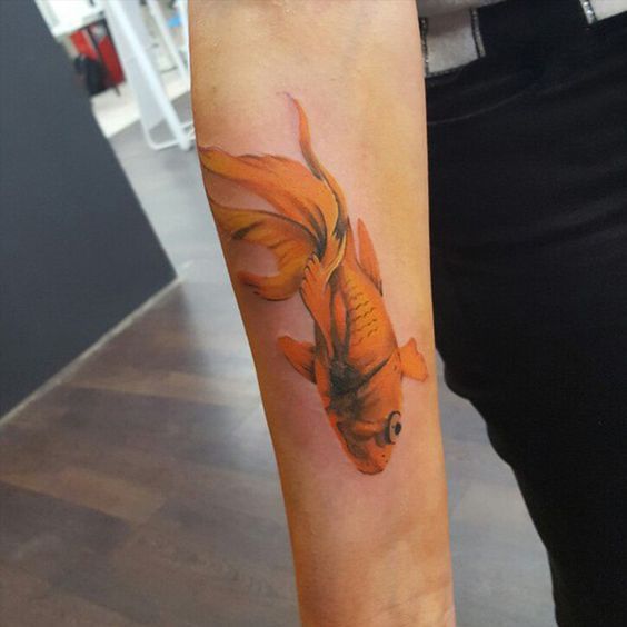 Large goldfish tattoo on the forearm for women