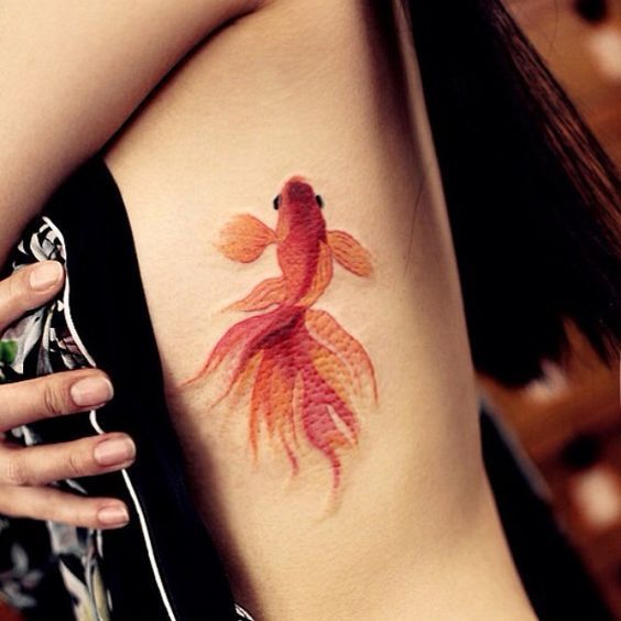 Colorful goldfish tattoo on the side for women