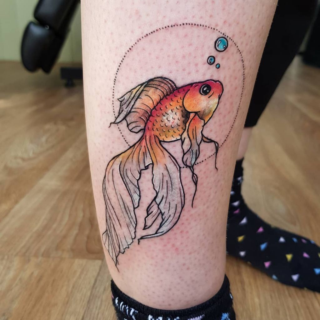 Large goldfish tattoo on the shin for women