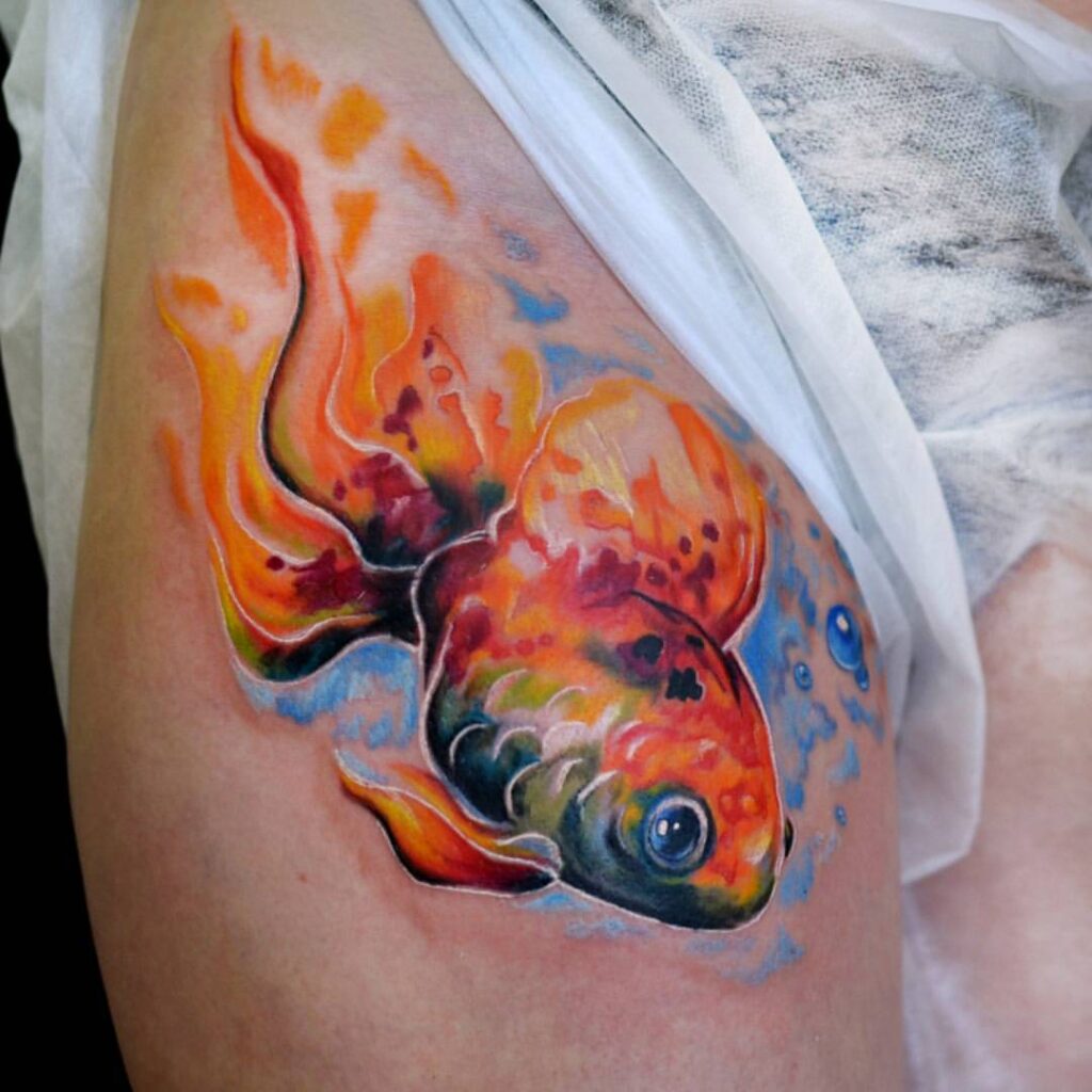 Large goldfish tattoo on the thigh for women