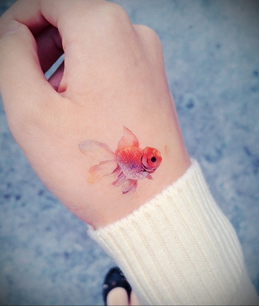 Small goldfish tattoo on the brush for women