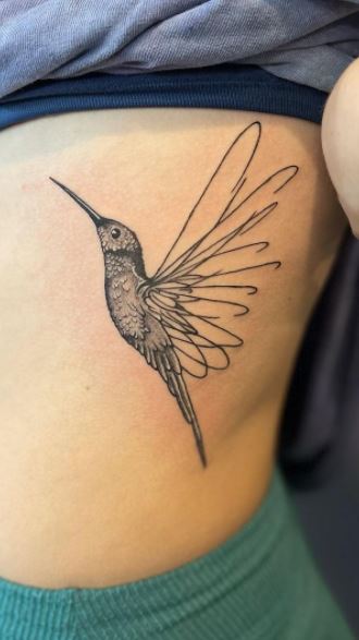 Large hummingbird tattoo on the side for women