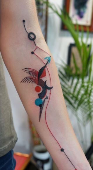 Colored hummingbird tattoo on the forearm for women