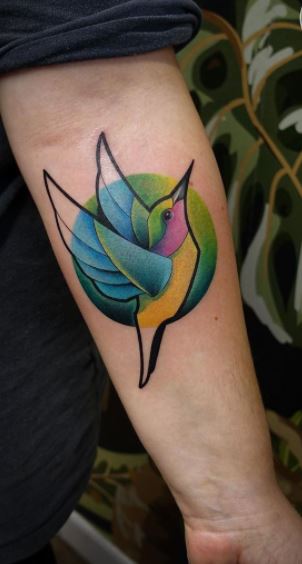 Colored hummingbird tattoo on the forearm for men