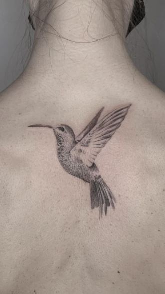 Large hummingbird tattoo on the back for women