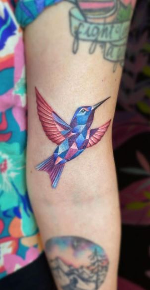 Colored hummingbird tattoo on the shoulder for women