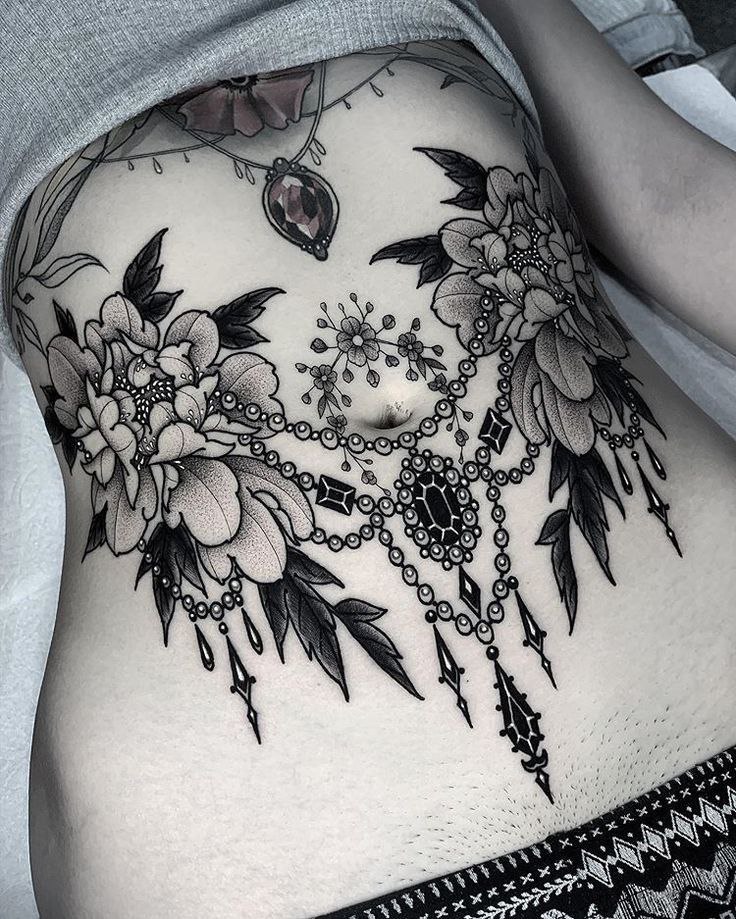 Large flower tattoo on the abdomen for women