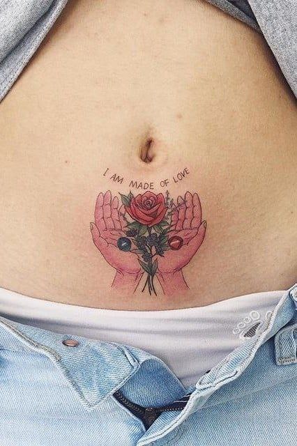 Color hand tattoo on the abdomen for women