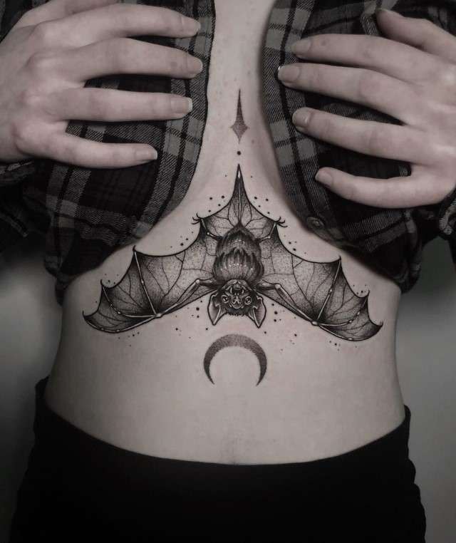 Tattoo of a flying bear on the stomach for women