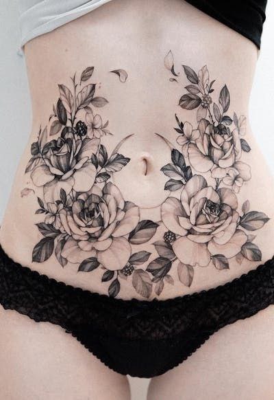 Large flower tattoo on the abdomen for women