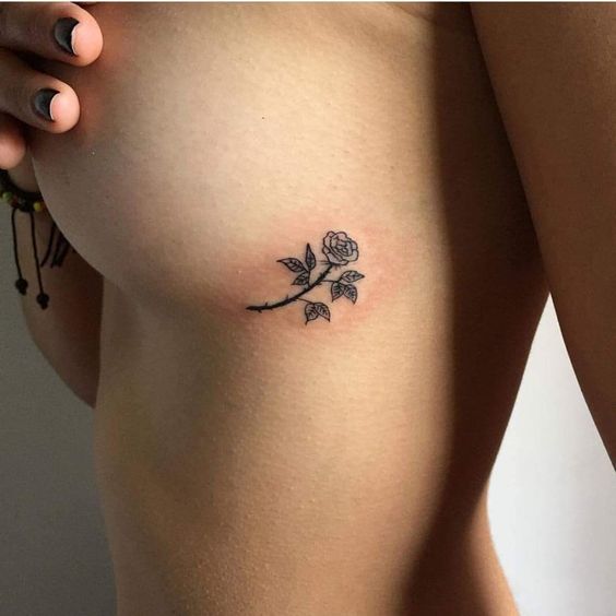 Intimate rose tattoo on the chest for women