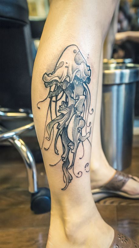 Jellyfish tattoo on the shin for women