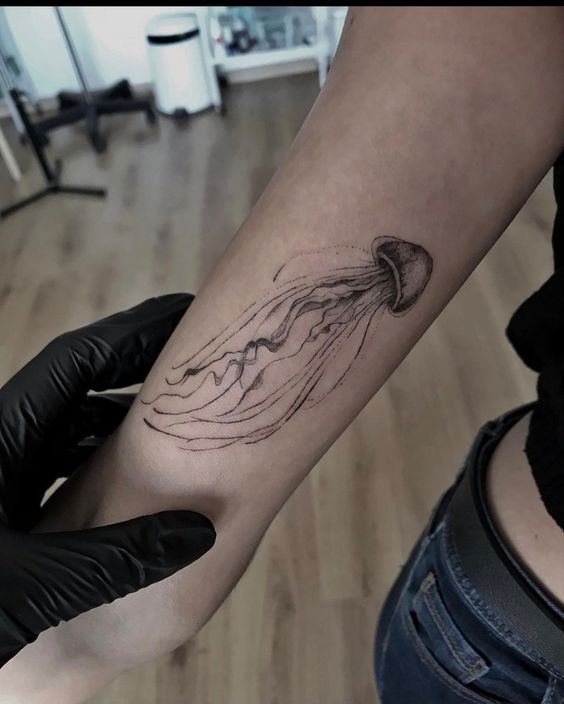 Jellyfish tattoo on the forearm for women