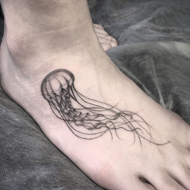 Large jellyfish ankle tattoo for women