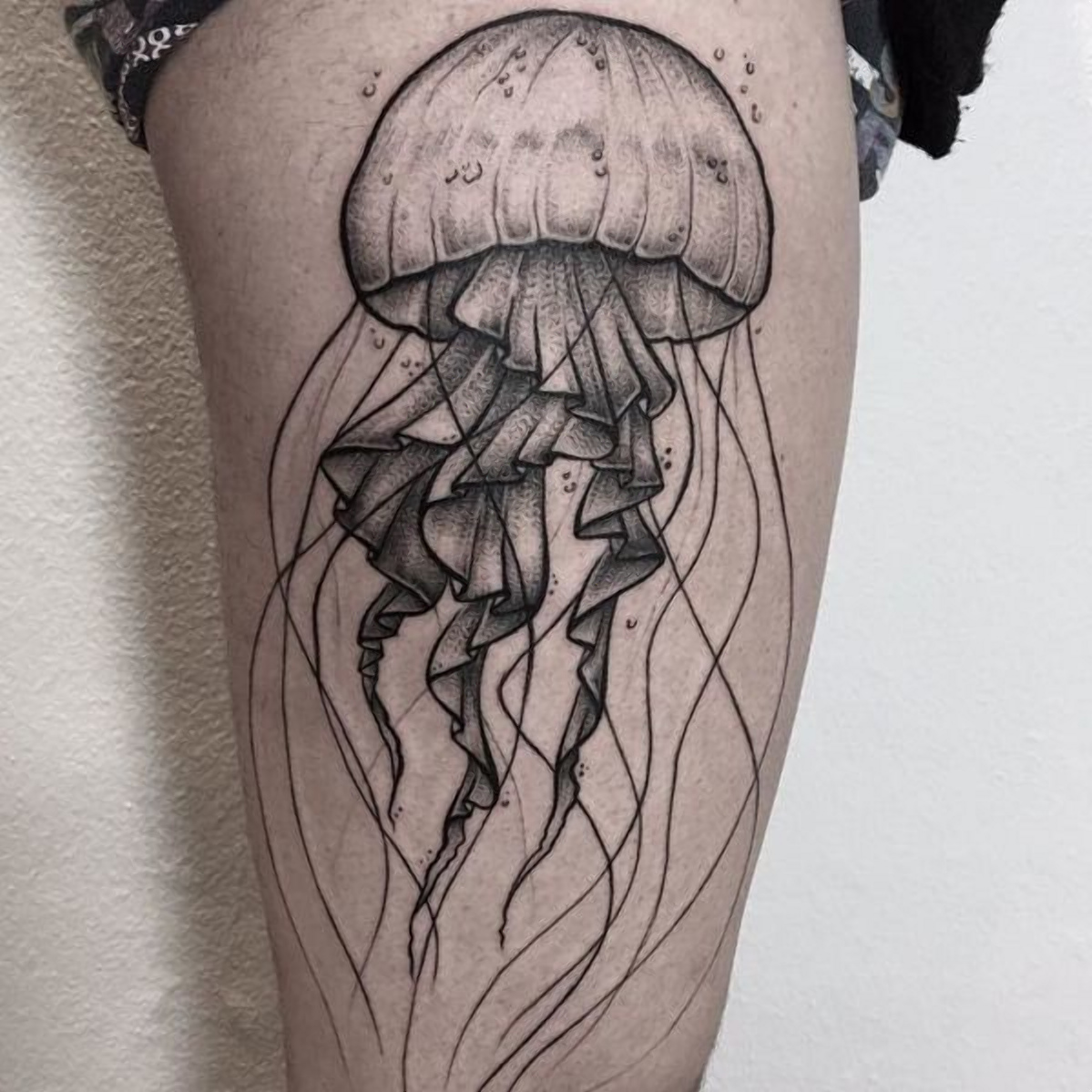 Large jellyfish tattoo on the thigh for men