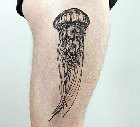 Jellyfish tattoo with flowers on the thigh for men