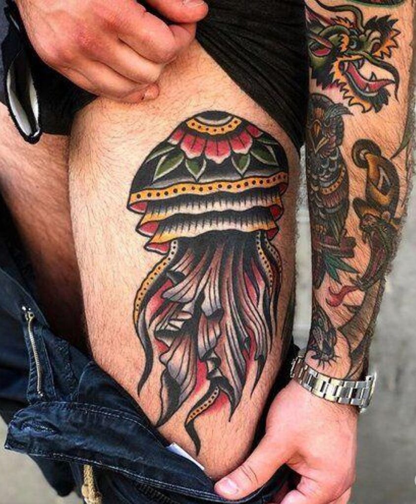 Colored jellyfish tattoo on the thigh for men