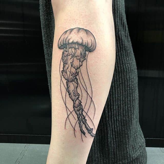 Large jellyfish tattoo on the forearm for men