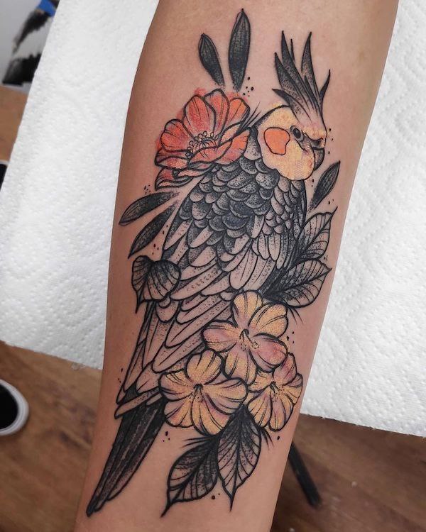 Large parrot tattoo on the forearm for women