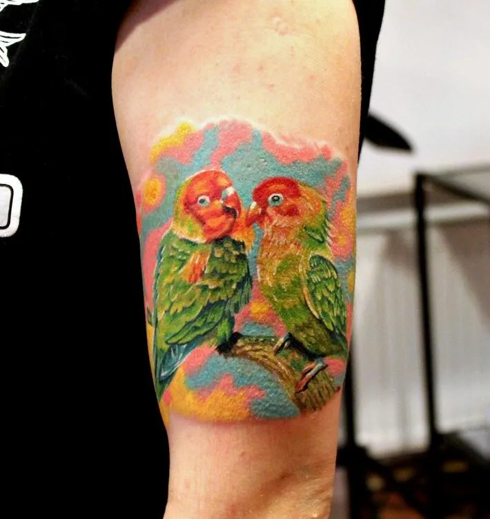 Large tattoo of two parrots on the shoulder for men