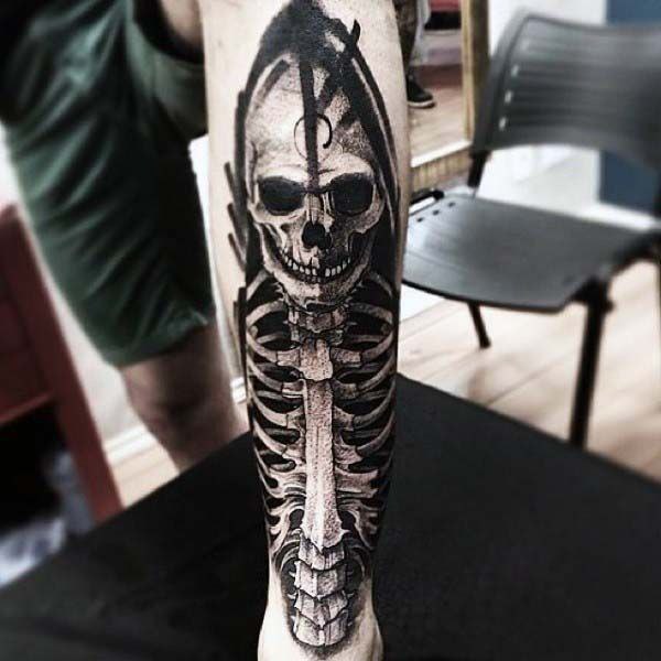 Large skeleton tattoo on the shin for men