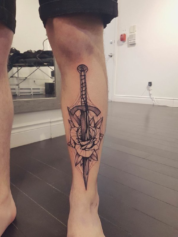 Tattoo of a dagger and a rose on the shin for men