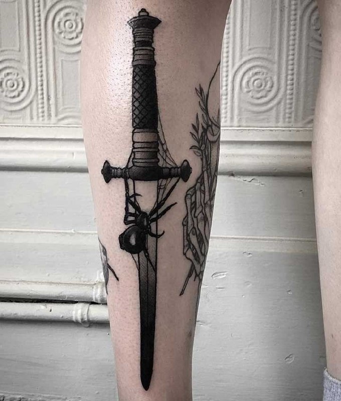 Large dagger and spider tattoo on the shin for men