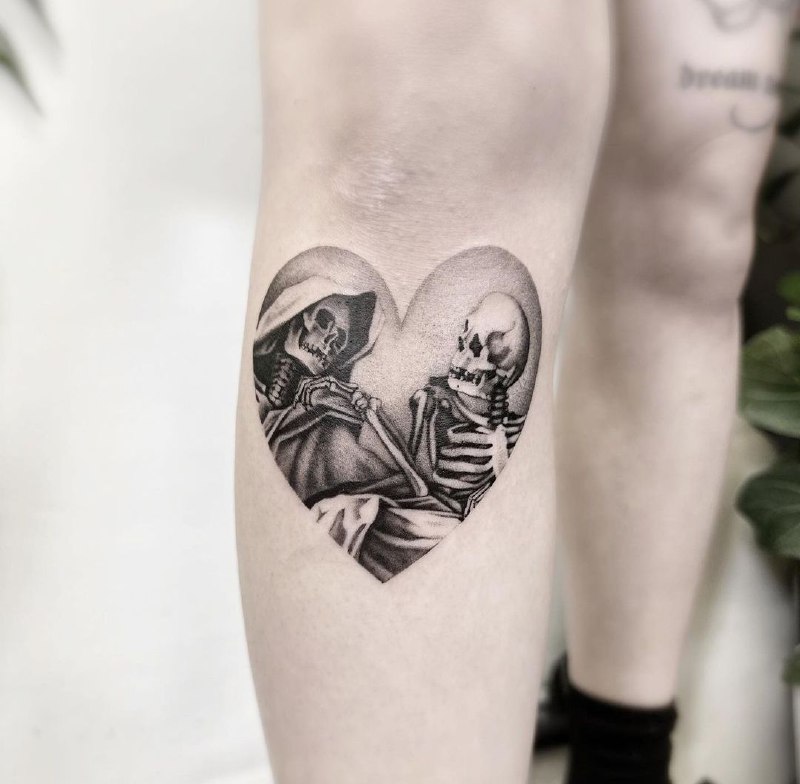 Tattoo of two skeletons and a heart on the shin for men