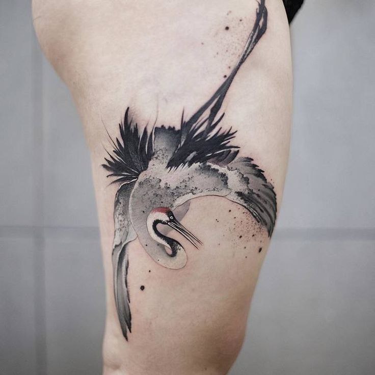 Colorful stork tattoo on the hip for women