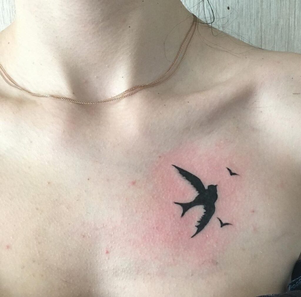 Small swallow tattoo on the chest for women