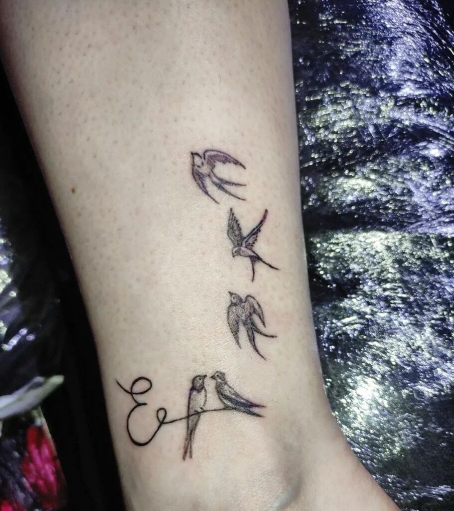 Small tattoo of five swallows on the shin for women