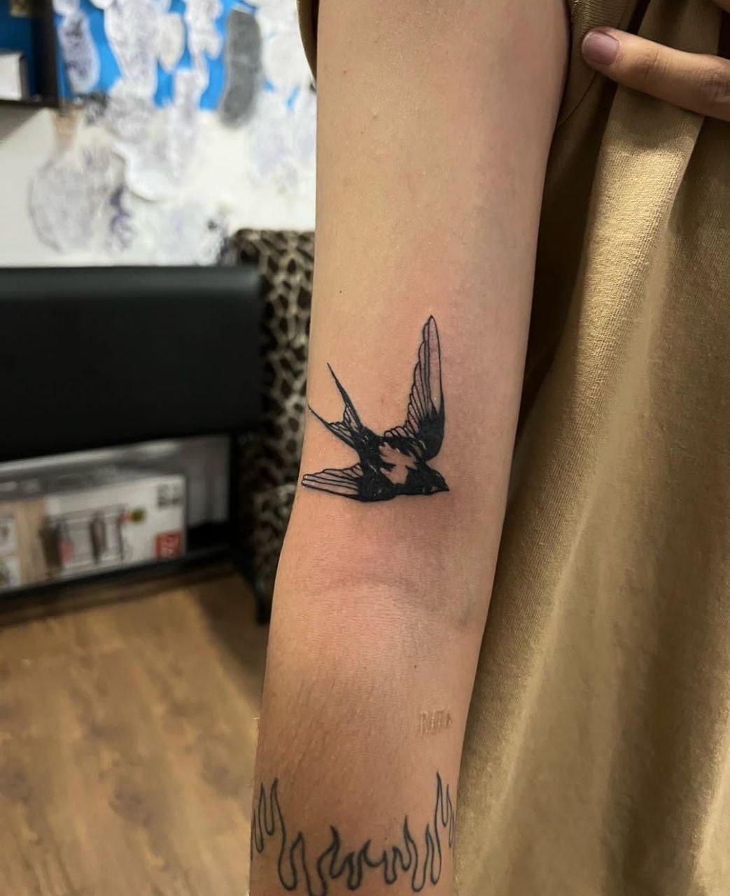 Swallow tattoo on the arm for women