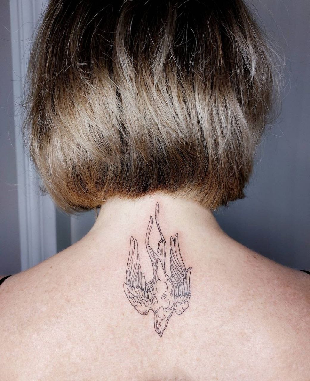 Large swallow neck tattoo for women