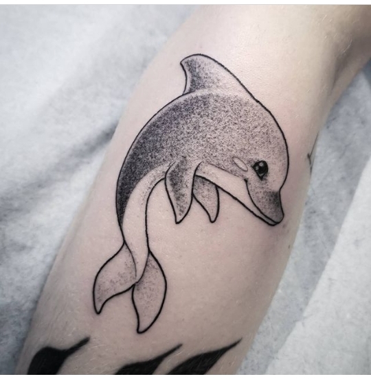 Dolphin tattoo on the shin for women