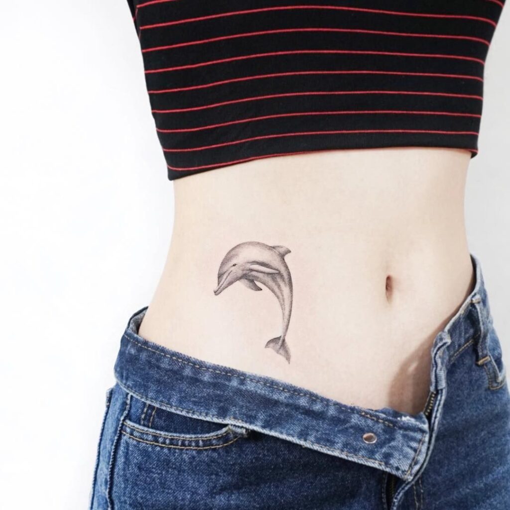 Dolphin tattoo on the side for women